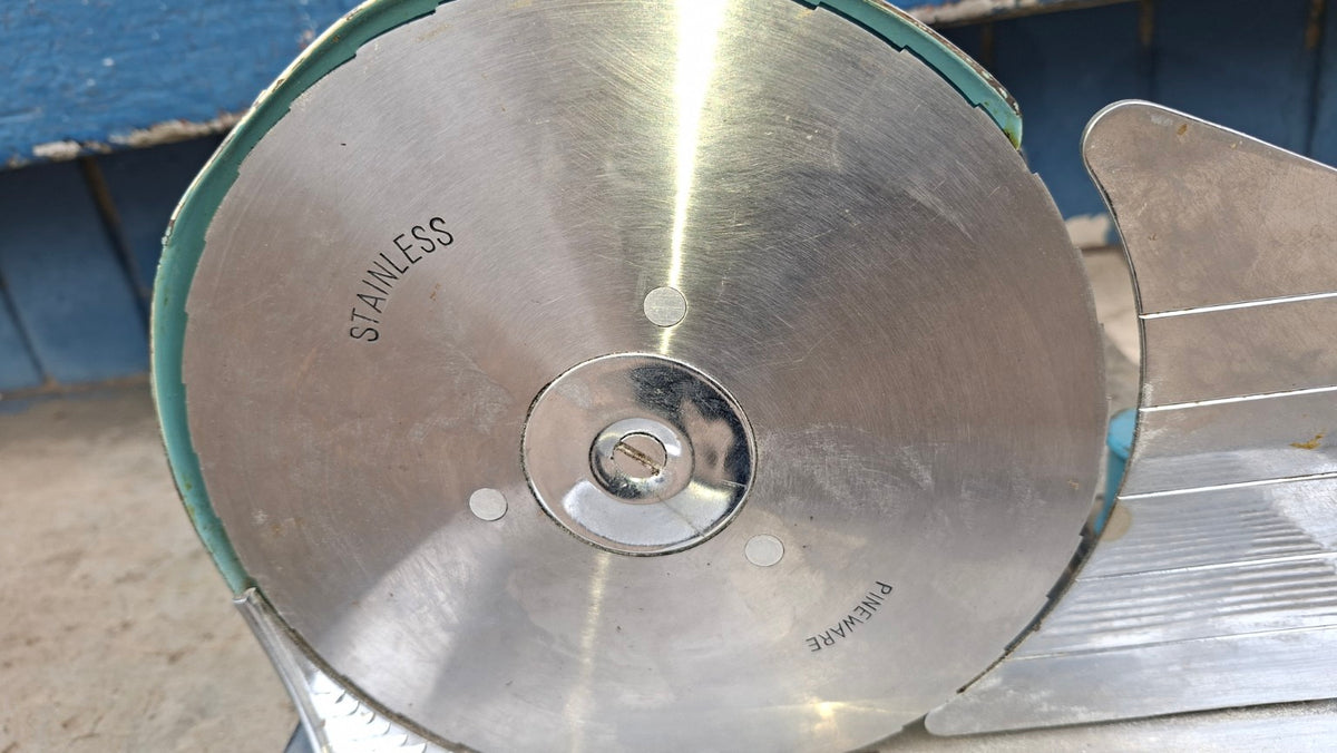 Manual turquoise stainless steel food slicer blade detail
